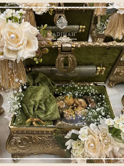 This olive green Rajwada Box, filled with treats and a scroll, exudes classic luxury.
