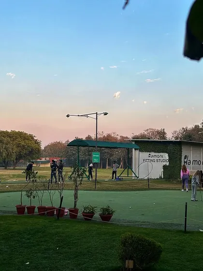 A view of the putting green and Fitting Studio at dusk, a peaceful time at the camp.