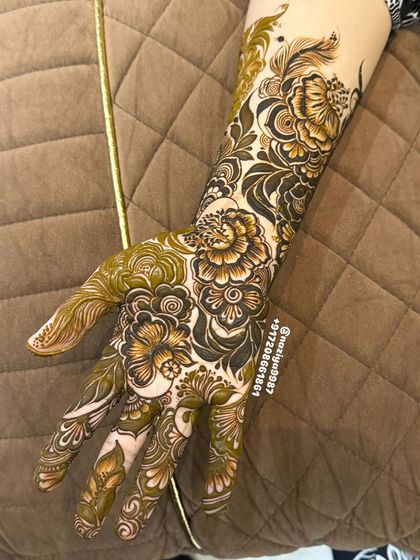 A close-up of a 3D floral design on the hand. The careful shading makes the petals look like they are lifting off the skin.