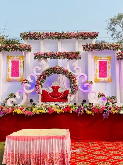 A full view of the ornate white and pink stage, showing its grand scale and intricate floral details.