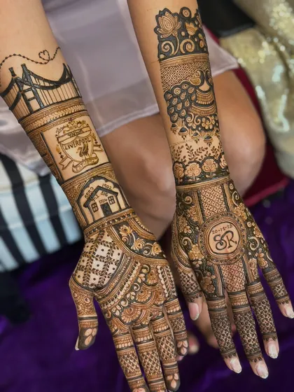 Here you can see the combination of a city bridge, a house, and the couple's initials monogram, all surrounded by traditional Indian mehendi patterns.