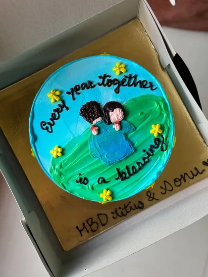 A custom cake celebrating a couple's birthday with the message "Every year together is a blessing".