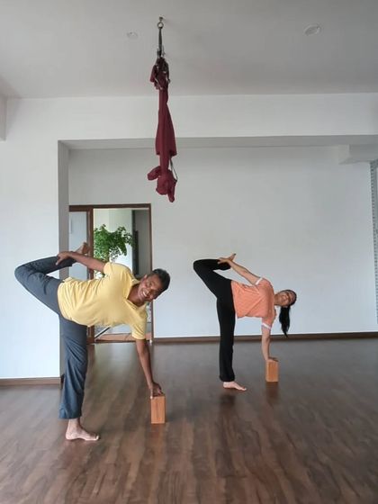 Practice is progressing for our Natarajasana challenge. Here, students use blocks for support in Ardha Chandrasana Chapasana, a preparation for the full pose.