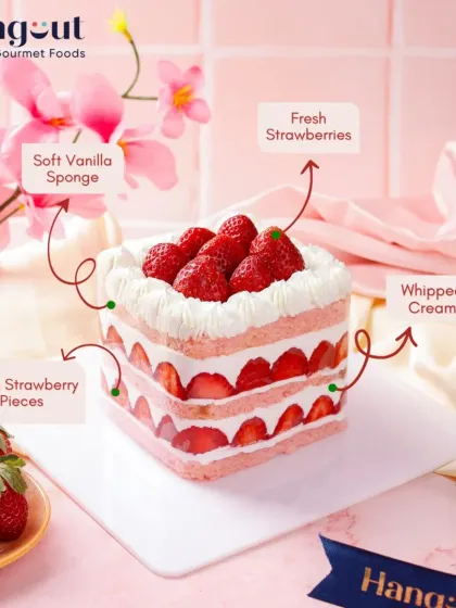 This is our Fresh Strawberry Cake, deconstructed. You can see the layers of soft vanilla sponge, light whipped cream, and generous pieces of fresh, seasonal strawberries. We believe in using high quality ingredients you can see and taste.