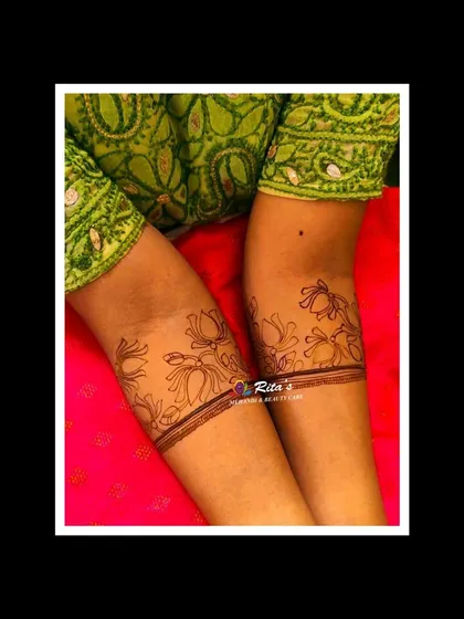 The initial outline of the floral startup, showing how the design begins before the dark henna paste is applied for shading.