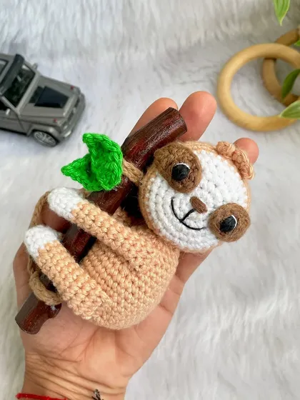 This adorable sloth car hanging was so much fun to make. He hangs lazily from a real wooden branch, adding a touch of cuteness to your car's rearview mirror.
