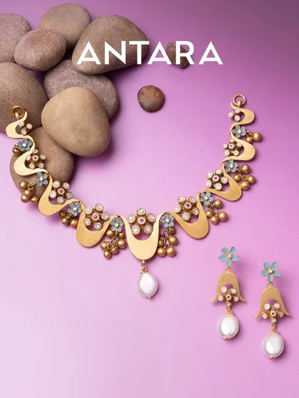 I believe gold jewellery should be light in weight but heavy on impact. This 22kt matte gold necklace and earring set, with its intricate floral details and pearl drops, is designed for those who move differently and appreciate modern artistry.
