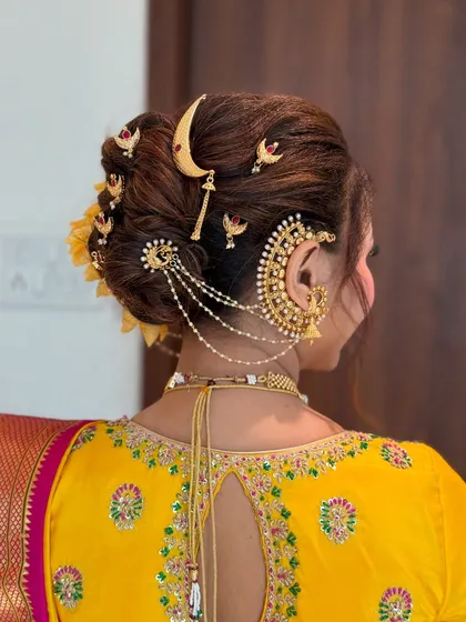 A detailed close-up of the hair accessories on the Khopa, showcasing the craftsmanship of both the jewelry and the hairstyle.