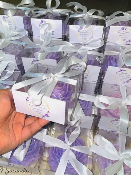 A bulk order of our lilac peony candles, ready to be gifted. The custom packaging includes a personalized tag and a beautiful white ribbon.