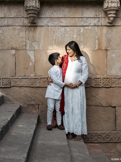 A quiet conversation between a boy and his mom's baby bump. This outdoor shot at a historic location adds a beautiful sense of timelessness.