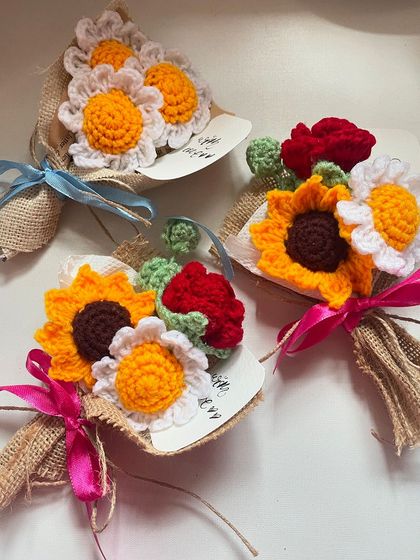 A trio of mini bouquets, two with sunflowers and one with daisies, showing the variety of small gifts available.