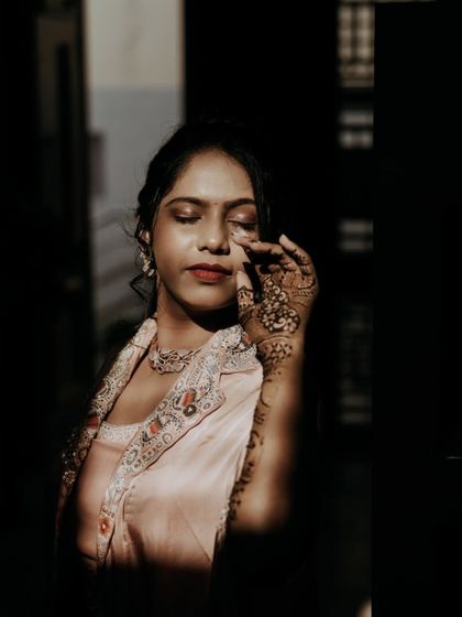 A dramatic portrait of the bride with her Mehendi, using shadows and light to create a moody effect.