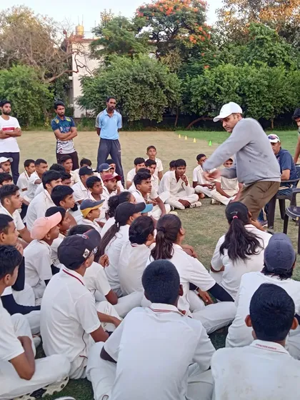 An interactive moment during a masterclass where our mentor uses gestures to explain a fielding position or batting stroke, making the lesson engaging and easy to understand.