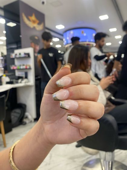 A stylish French manicure with a gold chrome tip, a modern and glamorous take on the classic design.