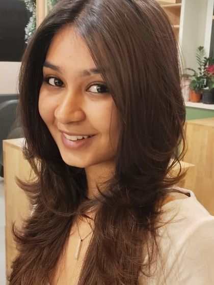 A happy client with her new layered cut. The style is fresh, modern, and easy to manage.