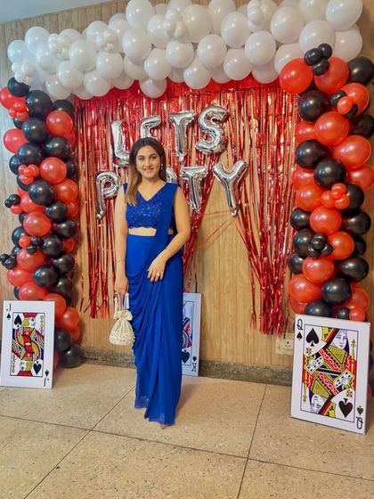 A full-length view showcasing the beautiful fall of the blue drape saree. The monochrome look is incredibly slimming and creates a tall, graceful line, proving that you can be both comfortable and glamorous.