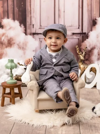 Dressed to impress for his first birthday! We style unique themed portraits like this "Little Gentleman" setup, complete with vintage-inspired props and outfits, to perfectly capture your baby's budding personality.