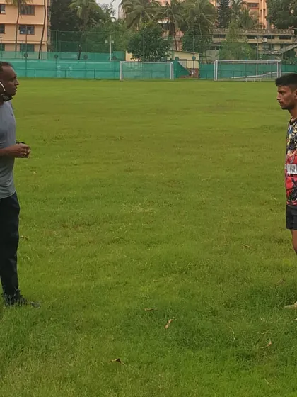 I believe in hands-on coaching. Here, I am providing post-workout feedback to an athlete, focusing on correcting form to maximize performance and prevent injuries.