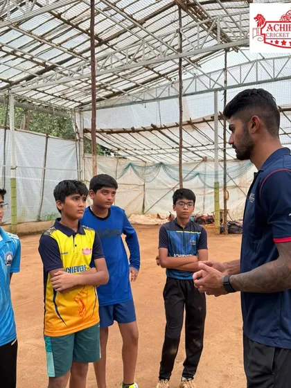 Aman Khan giving a focused talk to a small group of our players. These intimate mentorship sessions allow for direct learning and inspiration.
