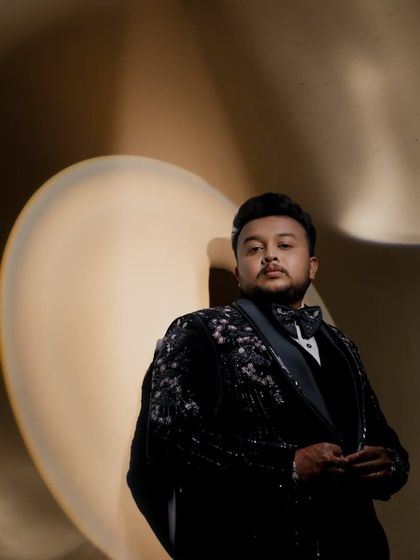 A creative and artistic portrait of the groom at his reception, using light and shadow.