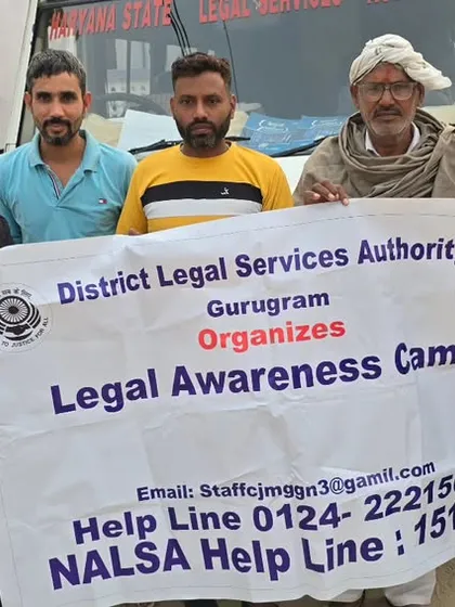 With local residents during a DLSA legal awareness campaign in a village. Holding our banner high, we bring information about free legal aid and helpline numbers directly to the people.