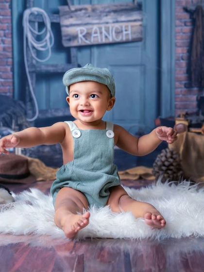 A moment of pure, uncontainable joy. This little boy's happy expression and excited pose are what make milestone sessions so much fun.