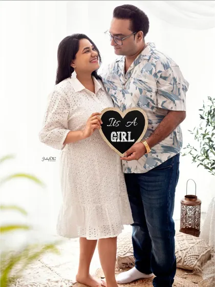 Sharing the wonderful news. This couple used a cute chalkboard sign to announce they are expecting a girl during their boho style maternity shoot.