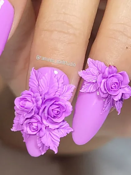 I specialize in creating detailed 3D nail art that makes a statement. This set features a full bouquet of intricate purple roses, sculpted by hand, on long almond-shaped nails for a bold and beautiful floral design.