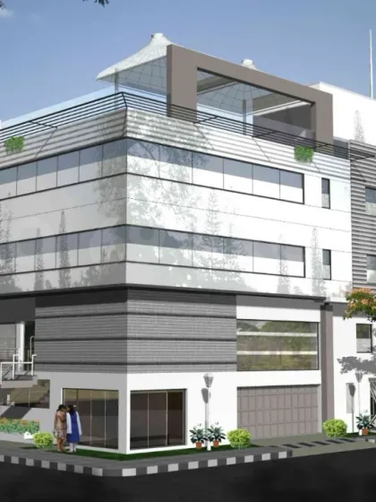 Another render for the project dedicated to Dr. Puneeth Rajkumar, showcasing a modern commercial building with clean lines and a rooftop terrace.