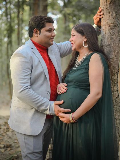 A loving gaze between the couple during their woodland maternity shoot. The soft, natural light of the forest creates a romantic and gentle atmosphere.