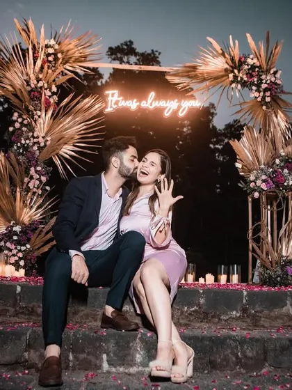 She said yes! A joyous moment captured as the couple celebrates their engagement in front of the beautiful decor we designed.