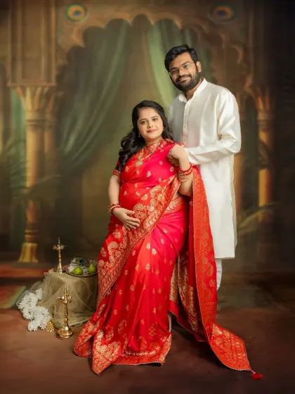 A classic couple portrait that feels royal and timeless. Dressed in a beautiful red saree, you two look absolutely radiant. These traditional studio sessions are perfect for creating elegant keepsakes.