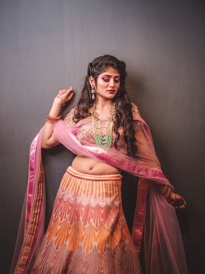 This portrait showcases a multi-colored lehenga with a modern design. The pose and lighting are designed to feature the outfit's unique pattern and the model's graceful posture.