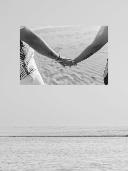 A simple, powerful black and white close-up of the couple holding hands. It's a small detail that speaks volumes about their connection.