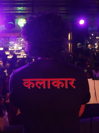 A view from the artist's perspective. The back of our 'Kalakar' (Artist) shirt, looking out at a sea of faces.