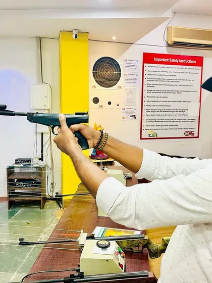 A customer takes aim with an air pistol. We provide clear safety instructions and guidance so even first-timers feel confident.