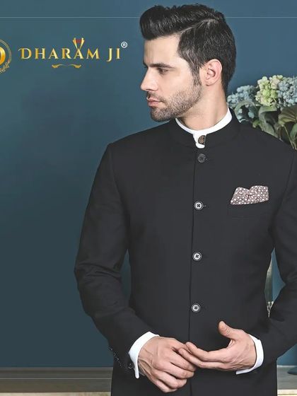 A classic black bandhgala or Jodhpuri suit. Its simplicity and elegance make it a timeless piece that can be dressed up or down for various occasions.