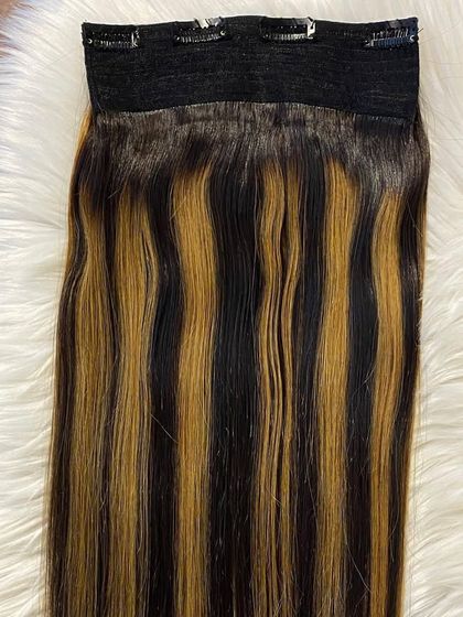 A detailed product shot of our highlighted clip-in extensions, showing the quality of the hair and the secure weft.