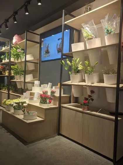 The multi-level display units we designed for FnP. This tiered setup allows for a variety of products, from small bouquets to larger plants, to be displayed attractively and accessibly.