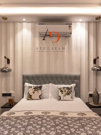 A symmetrical view of the light blue bedroom, highlighting the clean lines of the wall paneling and the balanced placement of bedside lights.