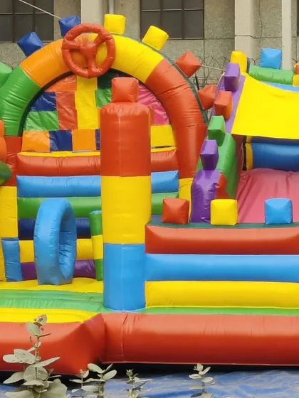 A very colorful and complex bouncy with many geometric shapes, pillars, and arches. This is a custom design with a lot of interactive elements.