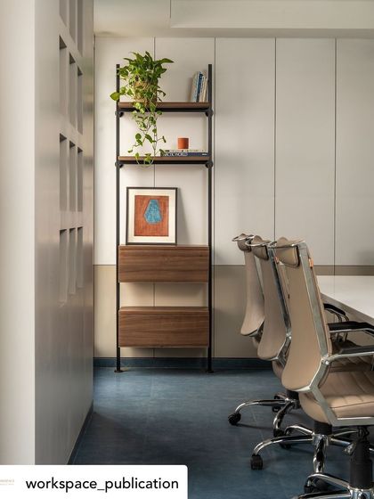 A duplicate of image 17, emphasizing the successful blend of modern furniture, natural elements, and a bold flooring choice in the office design.