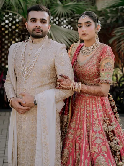 A powerful and poised portrait of the couple, ready to begin their life together. Their coordinated outfits and strong presence make for a striking image.