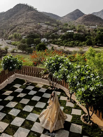 A bride against a breathtaking landscape. I love using stunning destination wedding backdrops like the mountains of Udaipur to create truly epic bridal portraits.