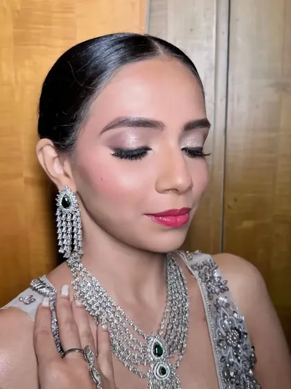 A glamorous cocktail look with shimmery eyes and a bright pink lip. This makeup is designed to be vibrant and eye-catching, perfect for a night of celebration.