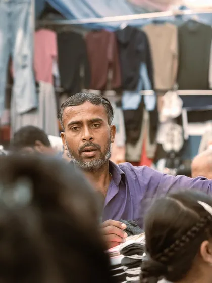 The focused expression of a street vendor in a busy market. These portraits are a tribute to the hardworking people of Delhi.