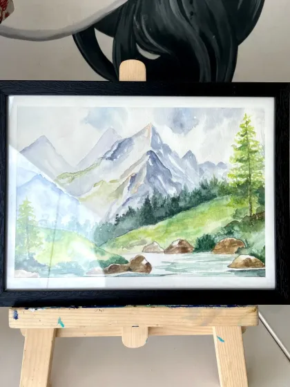 A serene watercolor painting of a mountain landscape, created by a student in our watercolor course.