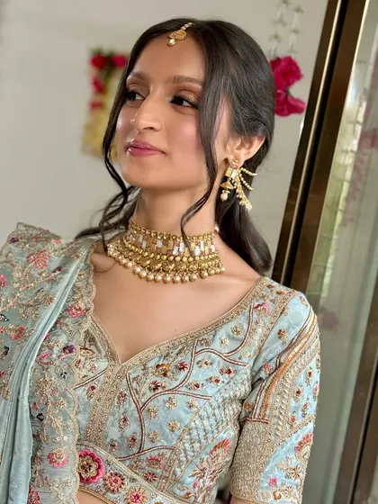 A three-quarter view of the bride, looking elegant and happy.