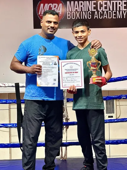 Himanshu Dudhade, awarded "Sportsperson of the Year" by his school, holding his trophy and certificate with me in the ring.
