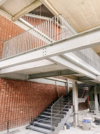 The steel framework of a staircase and mezzanine at the Play Arena project. This highlights my studio's expertise in steel buildings and creating layered, multi-level spaces.